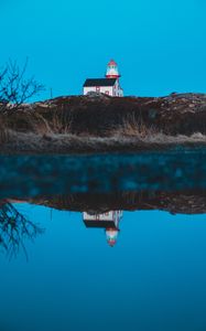 Preview wallpaper lighthouse, building, hill, water, reflection