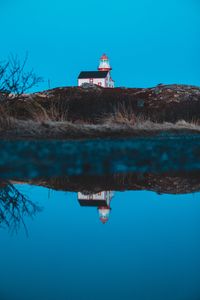 Preview wallpaper lighthouse, building, hill, water, reflection