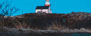 Preview wallpaper lighthouse, building, hill, water, reflection