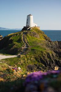 Preview wallpaper lighthouse, building, path, coast, sea