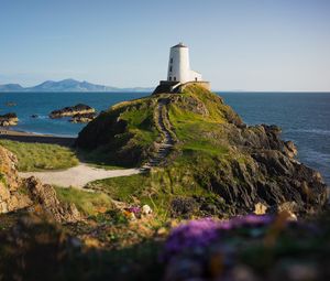 Preview wallpaper lighthouse, building, path, coast, sea