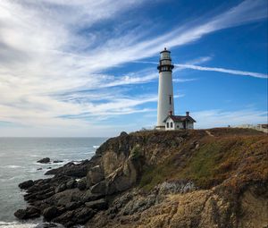 Preview wallpaper lighthouse, building, rocks, coast, sea