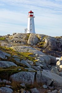 Preview wallpaper lighthouse, building, rocks, sea, sky