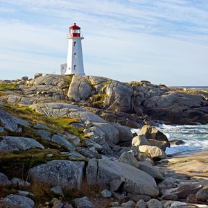 Preview wallpaper lighthouse, building, rocks, sea, sky