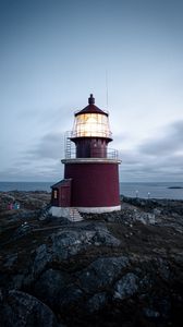 Preview wallpaper lighthouse, building, rocks, coast, sea, sky