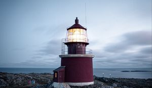 Preview wallpaper lighthouse, building, rocks, coast, sea, sky