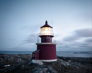 Preview wallpaper lighthouse, building, rocks, coast, sea, sky