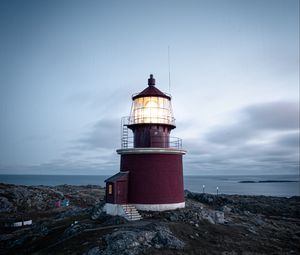 Preview wallpaper lighthouse, building, rocks, coast, sea, sky