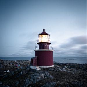 Preview wallpaper lighthouse, building, rocks, coast, sea, sky