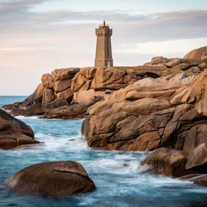 Preview wallpaper lighthouse, building, rocks, coast, stones, sea