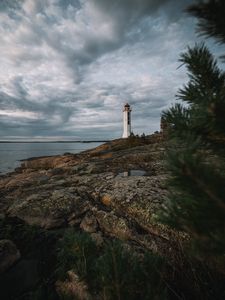 Preview wallpaper lighthouse, building, sea, rocks, sky