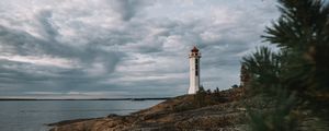 Preview wallpaper lighthouse, building, sea, rocks, sky