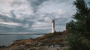 Preview wallpaper lighthouse, building, sea, rocks, sky