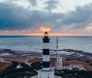 Preview wallpaper lighthouse, building, sea, sunset, horizon