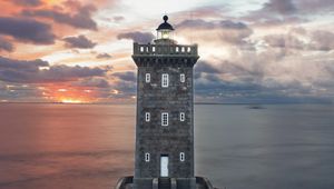 Preview wallpaper lighthouse, building, sea, shore, sunset