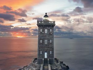 Preview wallpaper lighthouse, building, sea, shore, sunset