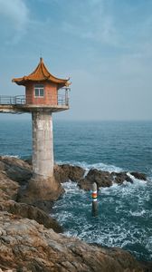 Preview wallpaper lighthouse, building, sea, coast, rocks, water