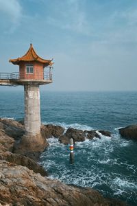 Preview wallpaper lighthouse, building, sea, coast, rocks, water