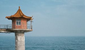 Preview wallpaper lighthouse, building, sea, coast, rocks, water