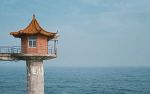 Preview wallpaper lighthouse, building, sea, coast, rocks, water