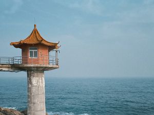 Preview wallpaper lighthouse, building, sea, coast, rocks, water