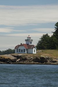 Preview wallpaper lighthouse, building, sea, coast, tree