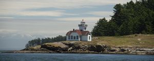 Preview wallpaper lighthouse, building, sea, coast, tree