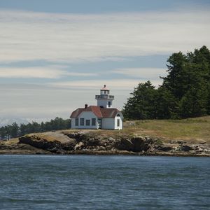 Preview wallpaper lighthouse, building, sea, coast, tree