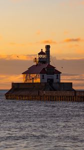 Preview wallpaper lighthouse, building, sea, sunset, waves