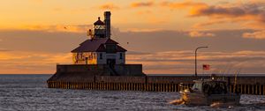 Preview wallpaper lighthouse, building, sea, sunset, waves