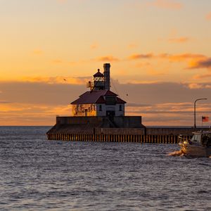 Preview wallpaper lighthouse, building, sea, sunset, waves