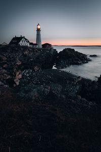 Preview wallpaper lighthouse, building, shore, sea, dusk