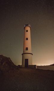 Preview wallpaper lighthouse, building, starry sky, stars, night, rocks