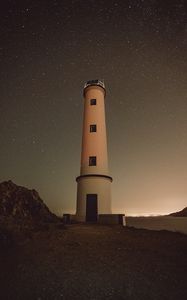 Preview wallpaper lighthouse, building, starry sky, stars, night, rocks