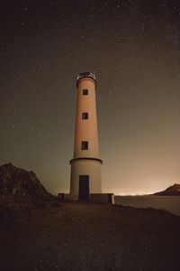 Preview wallpaper lighthouse, building, starry sky, stars, night, rocks