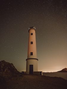 Preview wallpaper lighthouse, building, starry sky, stars, night, rocks