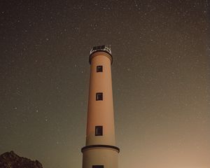 Preview wallpaper lighthouse, building, starry sky, stars, night, rocks