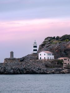 Preview wallpaper lighthouse, buildings, rock, sea