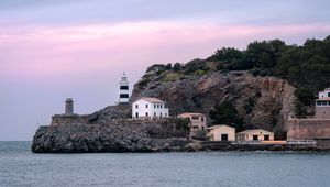 Preview wallpaper lighthouse, buildings, rock, sea