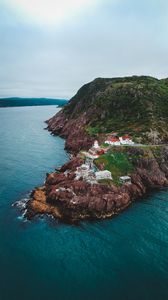 Preview wallpaper lighthouse, buildings, rocks, sea, slope