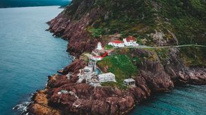 Preview wallpaper lighthouse, buildings, rocks, sea, slope