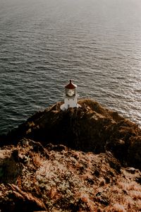 Preview wallpaper lighthouse, cliff, sea, aerial view, building
