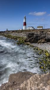 Preview wallpaper lighthouse, coast, foam, rocks