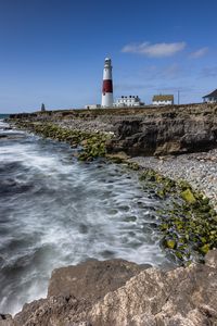 Preview wallpaper lighthouse, coast, foam, rocks