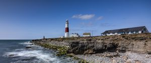 Preview wallpaper lighthouse, coast, foam, rocks