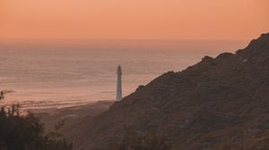 Preview wallpaper lighthouse, coast, fog, dusk