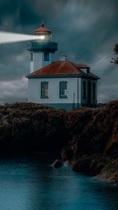 Preview wallpaper lighthouse, coast, glow, rocks, night