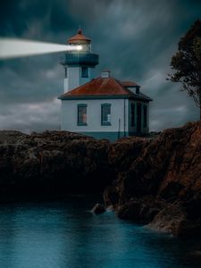 Preview wallpaper lighthouse, coast, glow, rocks, night