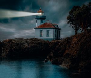 Preview wallpaper lighthouse, coast, glow, rocks, night