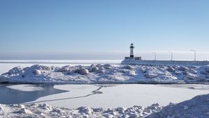 Preview wallpaper lighthouse, coast, snow, water, winter, nature